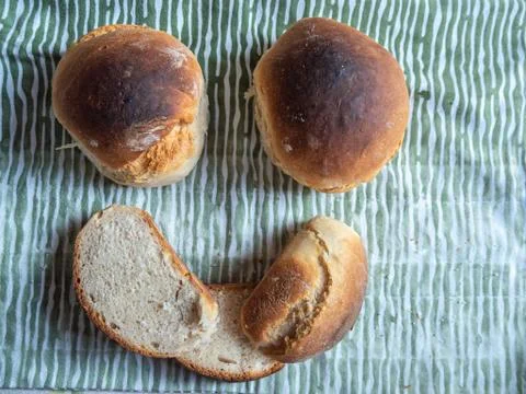 Freshly baked sliced bread on the table smiling face symbol. Stock Photos