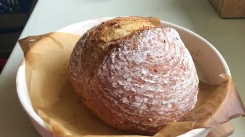 Freshly baked sourdough bread in baking dish rotation Stock Footage 164209507