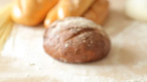 Freshly baked traditional bread cut in slices on a wooden table Stock Footage 65513308