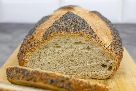 Freshly baked wheat bread. The concept of home baking. Stock Photos