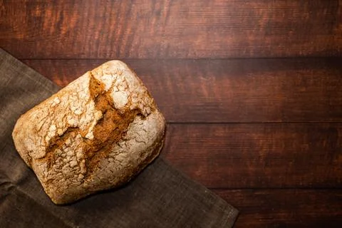 Freshly baked whole wheat bread bread on a gray dishcloth. Stock Photos