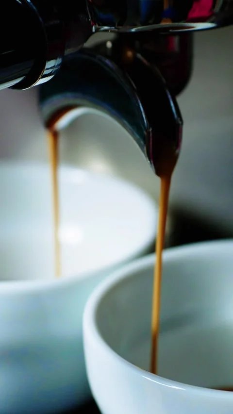 Freshly brewed coffee pouring into white cups at a cozy cafe in the morning Stock Footage 342797473