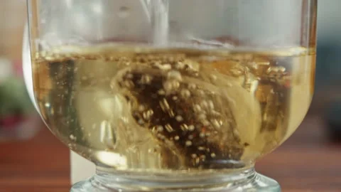 Freshly brewed cup of black tea on a wooden table, Tea ceremony process, fast Stock Footage 168893971