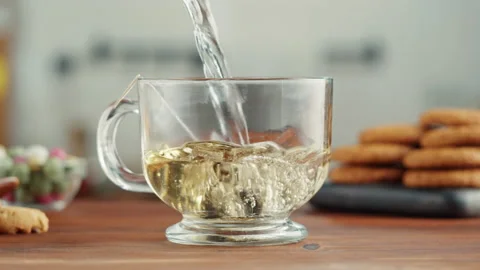 Freshly brewed cup of black tea on a wooden table, Tea ceremony process, fast Stock Footage 168894032