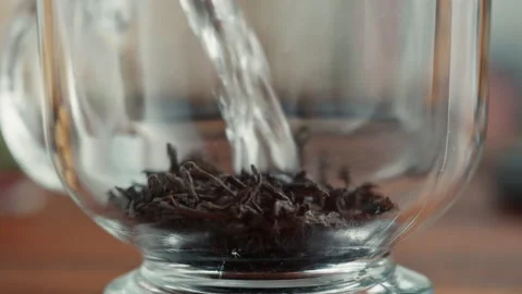 Freshly brewed cup of black tea on a wooden table, Tea ceremony process, fast Stock Footage 168894121