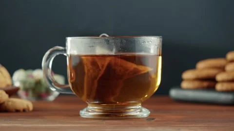 Freshly brewed cup of black tea on a wooden table, Tea ceremony process, fast Stock Footage 169110418