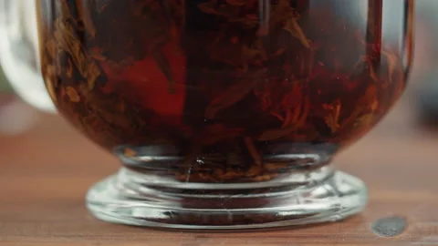 Freshly brewed cup of black tea on a wooden table, Tea ceremony process, fast Stock Footage 169111829