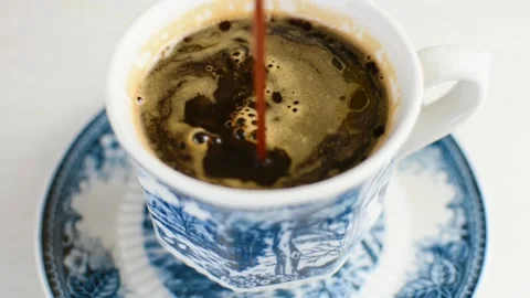 Freshly brewed hot coffee served in a porcelain coffee cup Stock Footage 137232437