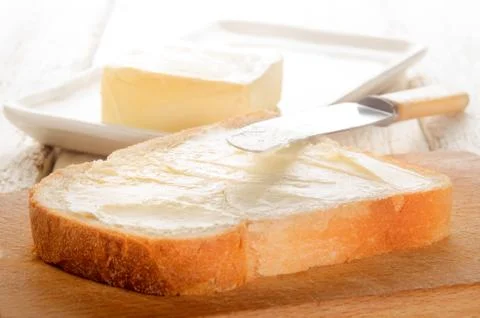 Freshly buttered slice of bread Stock Photos