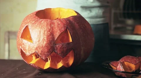 Freshly carved jack o lantern pumpkin on kitchen table Halloween theme close up Stock Footage 68177053