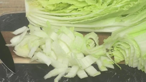 Freshly Chopped Cabbage is resting on a Cutting Board ready for your cooking Vídeo Stock 285511187