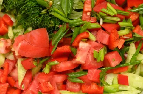 Freshly chopped vegetables create a vibrant salad, showcasing the beauty of.. 库存照片