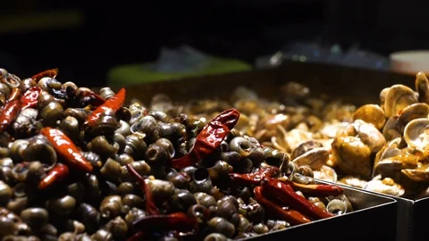 Freshly cooked boiled snails on the counter. Stock Footage 85814075