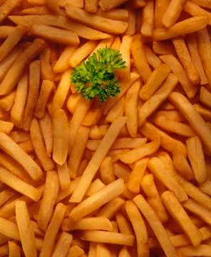 FRESHLY COOKED CHIPS BACKGROUND Stock Photos