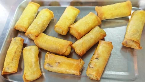 Freshly cooked crispy fried spring rolls on a stainless steel tray. Stock Footage 342392739