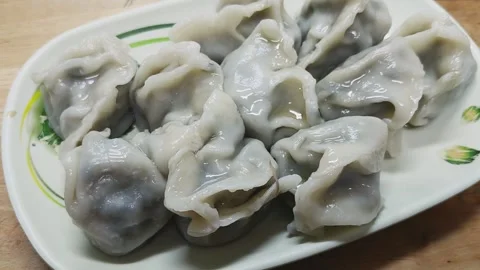 Freshly cooked dumplings arranged on a plate Stock Footage 342431891