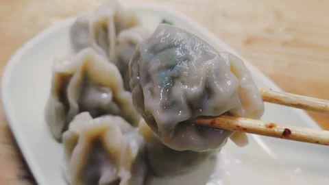 Freshly cooked dumplings arranged on a plate Stock Footage 342432089