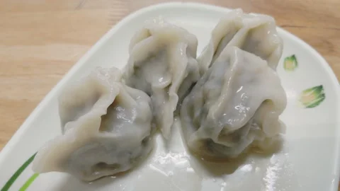 Freshly cooked dumplings arranged on a plate Stock Footage 342432147