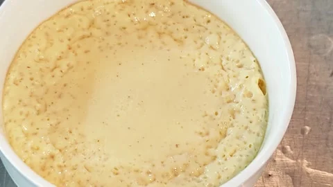 Freshly cooked homemade steamed egg custard in a white bowl. Stock Footage 342393692