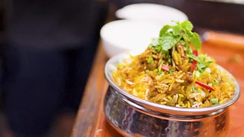 Freshly Cooked Indian Biryani Rice Served in Traditional Metal Bowl Stock Footage 346580436