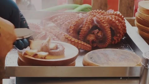 Freshly cooked octopus, chef cuts octopus with scissors Stock Footage 144009095