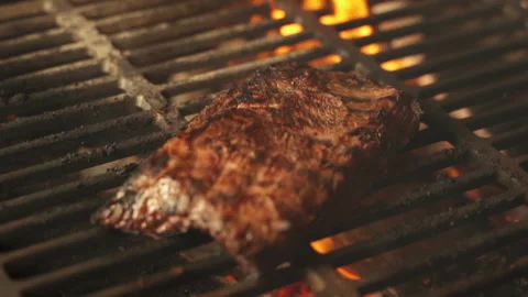 Freshly cooked pork or beef steak lies on a grill with a flame. Close up 스톡 동영상 157123623
