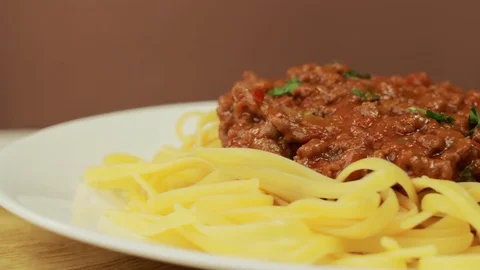 Freshly cooked spaghetti covered with tomato sauce, rotating Video stock 73970274