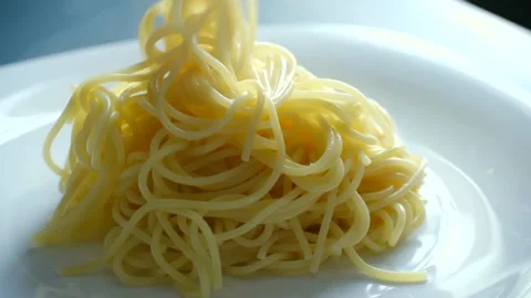 Freshly cooked spaghetti pasta falling on a white plate Stock Footage 337891685
