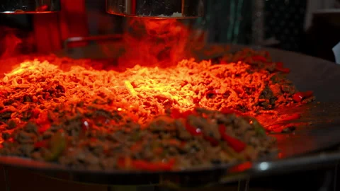 Freshly cooked stir fried noodles with seasoned beef and vegetables on a large Video stock 339846758