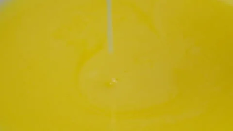 Freshly cooked warm liquid ghee clarified butter pouring macro texture. Stock Footage 308570228