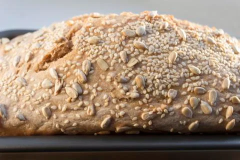 Freshly cooked white bread still in the bread pan Stock Photos