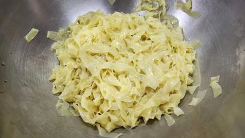 Freshly Cooked Wide Flat Egg Noodles in a Stainless Steel Mixing Bowl Stock Photos