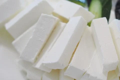 Freshly cut cheese displayed ready for a culinary application Stock Photos