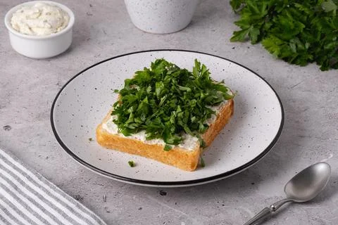 Freshly cut herbs on a slice of bread with cream cheese Stock Photos