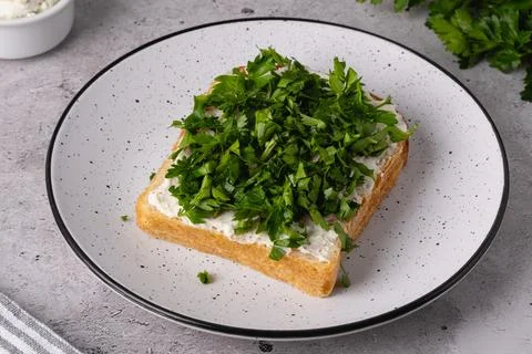 Freshly cut herbs on a slice of bread with cream cheese Stock Photos