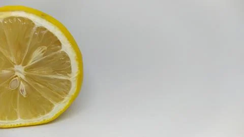 A Freshly Cut Lemon Slice Presented on a Light and Bright Background for Stock Photos