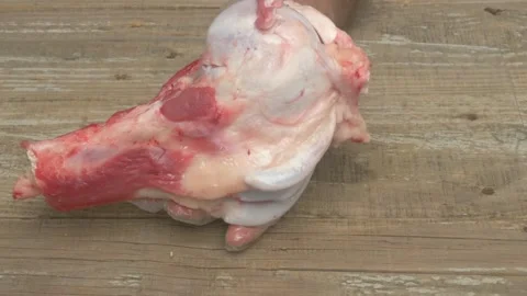 Freshly Cut Meat Displayed on a Rustic Wooden Surface for Culinary Purposes and Stock Footage 284133881