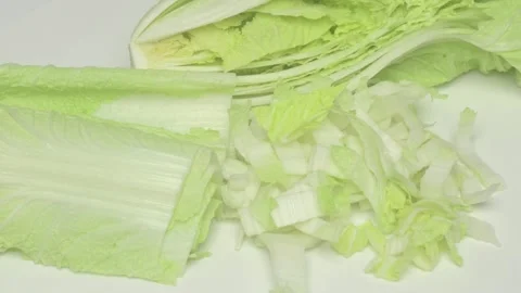 A Freshly Cut Napa Cabbage Displayed Beautifully on a Clean White Background Видео 285511547