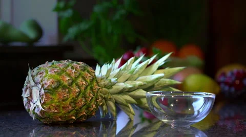 Freshly Cut Pineapple Falling Into Bowl On Kitchen Counter Stock Footage 62429989