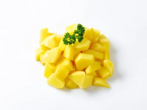 Freshly cut yellow corn kernels with parsley Stock Photos