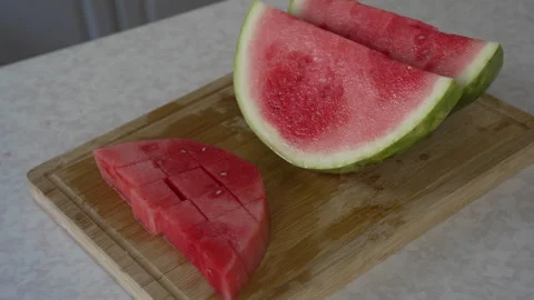 Freshly diced watermelon cubes and slice on wooden board Stock Footage 338120163