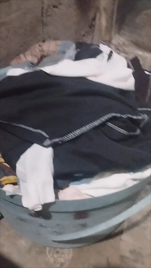 The freshly dried clothes are placed in the tub Stock Footage 295272528