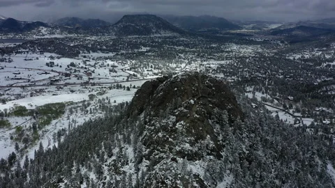 Freshly fallen snow coats the ground and mountains in Estes Park Colorado Stock Footage 247364137