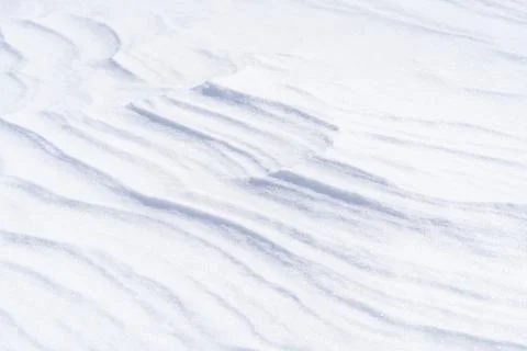 Freshly fallen snow surface looking like dunes shaped by wind. Stock Photos