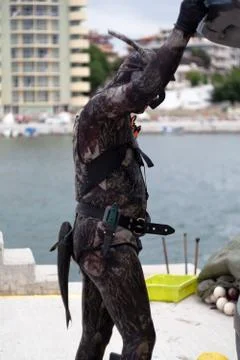 Freshly fish caught one by one from underwater diver on the sea shore Stock Photos