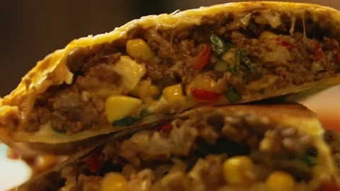 Freshly fried hot beef quesadilla and salsa on a wooden cutting board. Process Stock Footage 151296064