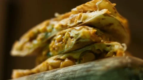 Freshly fried hot vegetable quesadilla on a wooden cutting board. Process of Stock Footage 151295457