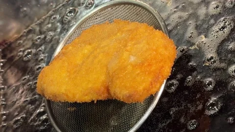 Freshly Fried Pork Cutlet On Strainer Draining Oil For Katsudon Japan Stock Footage 345479111