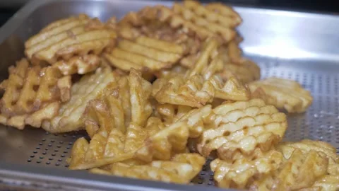 Freshly fried potatoes drained and prepared for table service Stock Footage 336793365