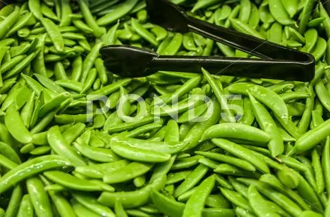 Freshly harvested peas on display at the farmers market Stock Photos